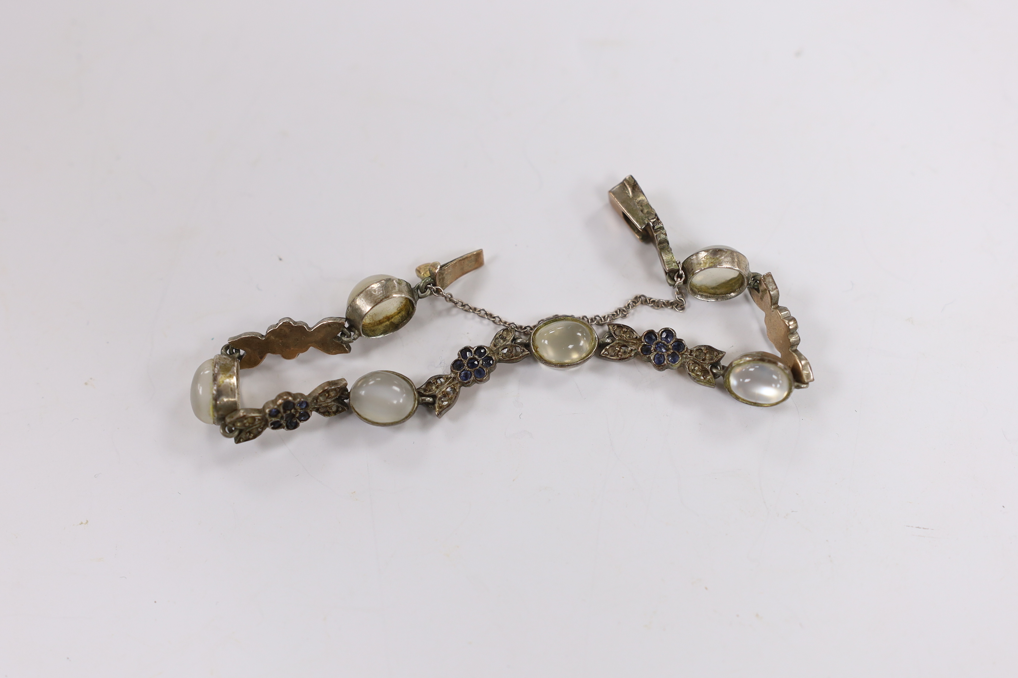 Two 9ct and gem set rings, one other costume ring, an unmounted oval cut synthetic ruby and a moonstone and paste set white metal bracelet.